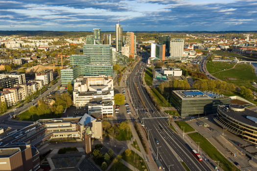 Vilnius Lithuania 01 May 2026 Aerial view of the modern business district skyline with glass skyscrapers wide urban roads and green parks under a blue sky. Vilnius Lithuania 01 May 2026 Aerial view of the modern business district skyline with glass skyscrapers wide urban roads and green parks under a blue sky.