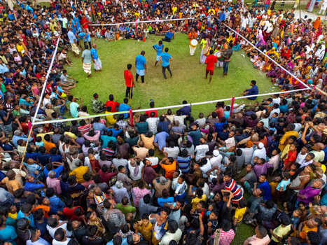 Nilphamari Bangladesh 01 May 2026 Aerial view of a large crowd gathered around a grassy arena for a traditional sporting event with drummers and participants. Nilphamari Bangladesh 01 May 2026 Aerial view of a large crowd gathered around a grassy arena for a traditional sporting event with drummers and participants.