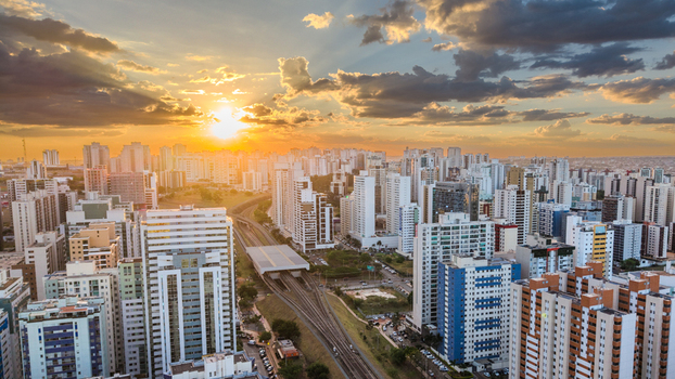 Brasilia Brazil 12 September 2026 Aerial view of the modern skyline of Brasilia at sunset with high rise buildings a railway track and a dramatic golden sky.