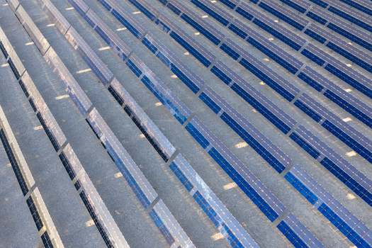 Aerial view of rows of blue solar panels reflecting the sunlight in a solar farm Enterprise Nevada United States. Aerial view of rows of blue solar panels reflecting the sunlight in a solar farm Enterprise Nevada United States.