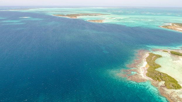 Aerial view of Los Roques archipelago featuring turquoise waters coral reefs and small islands in Los Roques Dependencias Federale Venezuela. Aerial view of Los Roques archipelago featuring turquoise waters coral reefs and small islands in Los Roques Dependencias Federale Venezuela.