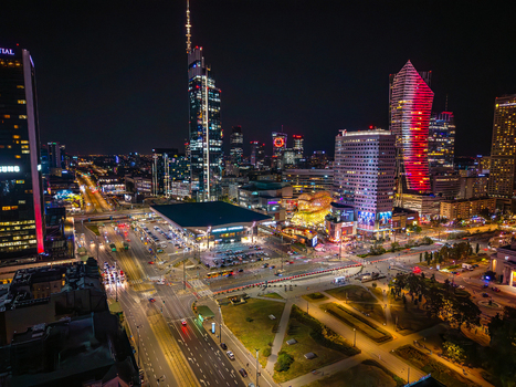 Aerial view of the modern city skyline at night with illuminated skyscrapers and busy streets in Warsaw Poland. Aerial view of the modern city skyline at night with illuminated skyscrapers and busy streets in Warsaw Poland.