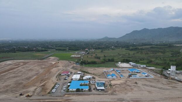 Aerial view of Dhoho International Airport construction site with blue roofed buildings cleared land and surrounding green landscape in Kecamatan Grogol Jawa Timur Indonesia. Aerial view of Dhoho International Airport construction site with blue roofed buildings cleared land and surrounding green landscape in Kecamatan Grogol Jawa Timur Indonesia.