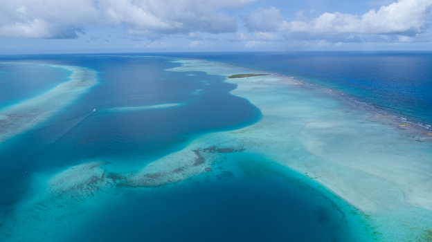 Aerial view of the turquoise waters and coral reefs of the Los Roques archipelago in Los Roques Dependencias Federales Venezuela. Aerial view of the turquoise waters and coral reefs of the Los Roques archipelago in Los Roques Dependencias Federales Venezuela.