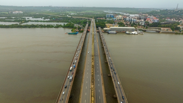 Aerial view of the Atal Setu bridge spanning the Mandovi River with traffic flowing across the multi lane structure in Panaji Goa India.