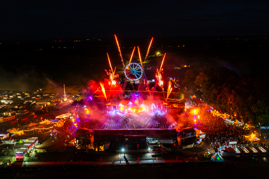 Herzogenaurach Germany 24 July 2025 Aerial view of Open Beatz Festival with fireworks exploding over the main stage a lit Ferris wheel and a large crowd at night.