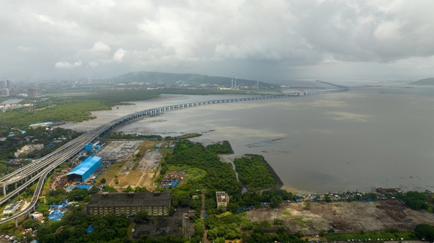 Aerial view of the Atal Bihari Vajpayee Sewri Nhava Sheva Atal Setu bridge spanning the water with surrounding mangroves and urban infrastructure in Mumbai Maharashtra India. Aerial view of the Atal Bihari Vajpayee Sewri Nhava Sheva Atal Setu bridge spanning the water with surrounding mangroves and urban infrastructure in Mumbai Maharashtra India.