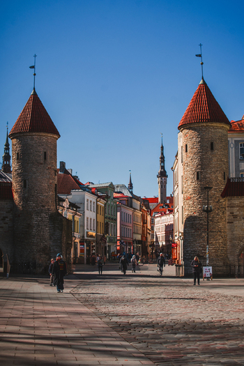 Tallinn Estonia 08 April 2026 View of the historic Viru Gate towers and cobblestone streets of Vanalinn with people walking under a clear blue sky. Tallinn Estonia 08 April 2026 View of the historic Viru Gate towers and cobblestone streets of Vanalinn with people walking under a clear blue sky.