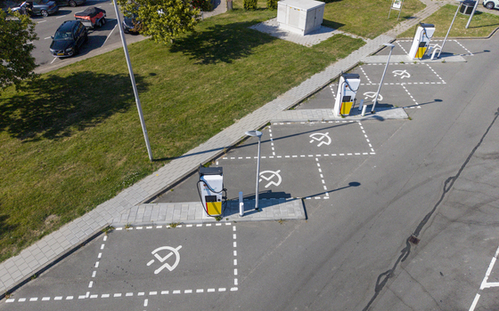 Aerial view of Shell Recharge Charging Station with multiple electric vehicle charging points and marked parking spaces in a paved lot in Lelystad Flevoland Netherlands. Aerial view of Shell Recharge Charging Station with multiple electric vehicle charging points and marked parking spaces in a paved lot in Lelystad Flevoland Netherlands.