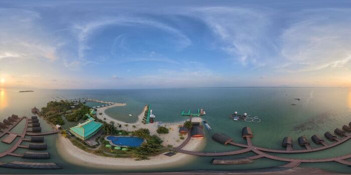Aerial view of Pulau Lima Resort featuring overwater bungalows a swimming pool sandy beaches and wooden walkways surrounded by the calm sea in Kasemen Banten Indonesia. Aerial view of Pulau Lima Resort featuring overwater bungalows a swimming pool sandy beaches and wooden walkways surrounded by the calm sea in Kasemen Banten Indonesia.
