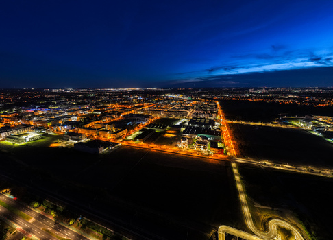 Aerial view of Technology Park Adlershof illuminated at night with modern office buildings research facilities and glowing street lights in Berlin Berlin Germany.