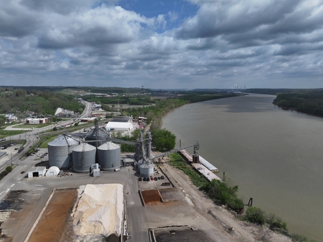 Aerial view of industrial grain silos and storage facility along the Ohio River bank under a cloudy sky in Aurora Indiana United States. Aerial view of industrial grain silos and storage facility along the Ohio River bank under a cloudy sky in Aurora Indiana United States.