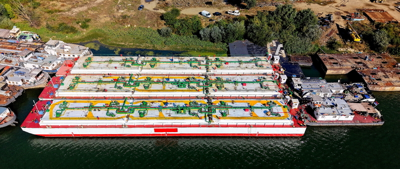 Aerial view of a large industrial barge docked at the shipyard with complex piping systems on deck in Smederevo Podunavlje District Serbia. Aerial view of a large industrial barge docked at the shipyard with complex piping systems on deck in Smederevo Podunavlje District Serbia.