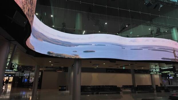 View of the curved digital screen at Helsinki Airport Finland.