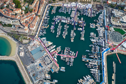 Aerial view of the Vieux Port de Cannes filled with luxury yachts and boats surrounded by historic urban architecture and coastal landscape in Cannes Provence Alpes Cote d Azur France. Aerial view of the Vieux Port de Cannes filled with luxury yachts and boats surrounded by historic urban architecture and coastal landscape in Cannes Provence Alpes Cote d Azur France.