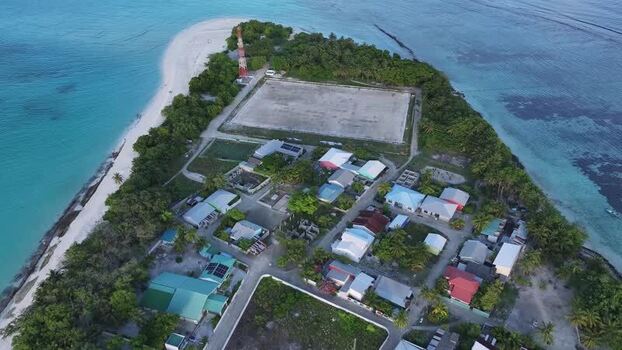 Aerial view of Vashafaru island village and beach Maldives. Aerial view of Vashafaru island village and beach Maldives.