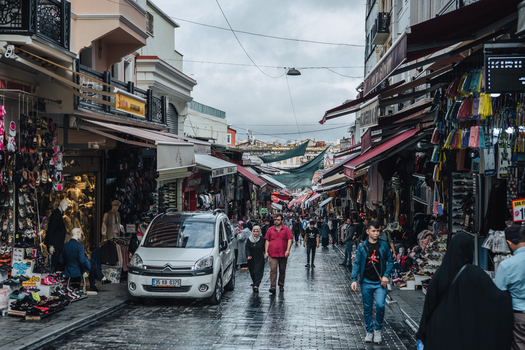 Istanbul Turkiye 05 October 2019 View of a bustling street with vibrant shops and people walking under the soft diffused light of an overcast sky.