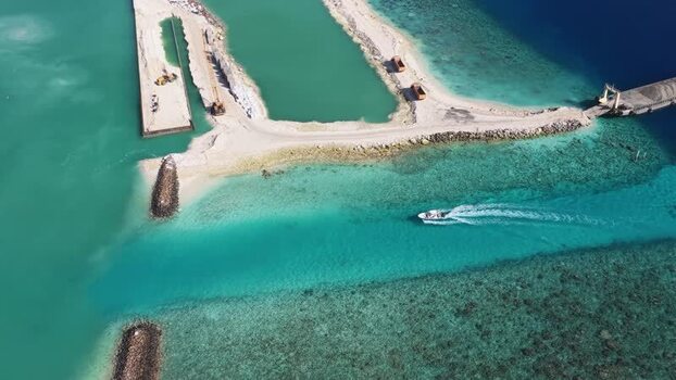 Aerial view of a boat in a turquoise channel Maldives. Aerial view of a boat in a turquoise channel Maldives.
