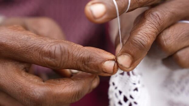 View of hands crocheting white lace Bangladesh. View of hands crocheting white lace Bangladesh.
