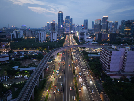 Aerial view of Jalan Gatot Subroto highway with evening traffic modern skyscrapers and elevated rail line in Kecamatan Mampang Prapatan Daerah Khusus Ibukota Indonesia. Aerial view of Jalan Gatot Subroto highway with evening traffic modern skyscrapers and elevated rail line in Kecamatan Mampang Prapatan Daerah Khusus Ibukota Indonesia.