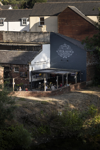 Durham United Kingdom 13 July 2026 View of The Half Moon Inn with its outdoor seating area brick wall and dark painted wall featuring signage situated in a historic urban setting. Durham United Kingdom 13 July 2026 View of The Half Moon Inn with its outdoor seating area brick wall and dark painted wall featuring signage situated in a historic urban setting.