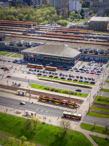 Aerial view of the Warszawa Wschodnia railway station with a yellow tram buses and parking lot surrounded by greenery in Poland. Aerial view of the Warszawa Wschodnia railway station with a yellow tram buses and parking lot surrounded by greenery in Poland.