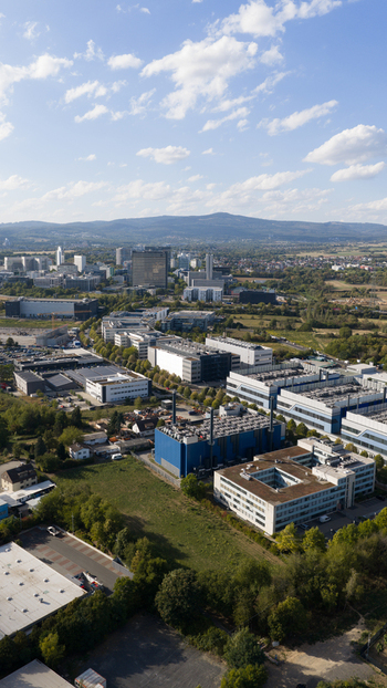 Aerial view of the Sossenheim datacenters featuring large industrial buildings cooling systems and green spaces under a blue sky in Frankfurt am Main Hessen Germany. Aerial view of the Sossenheim datacenters featuring large industrial buildings cooling systems and green spaces under a blue sky in Frankfurt am Main Hessen Germany.