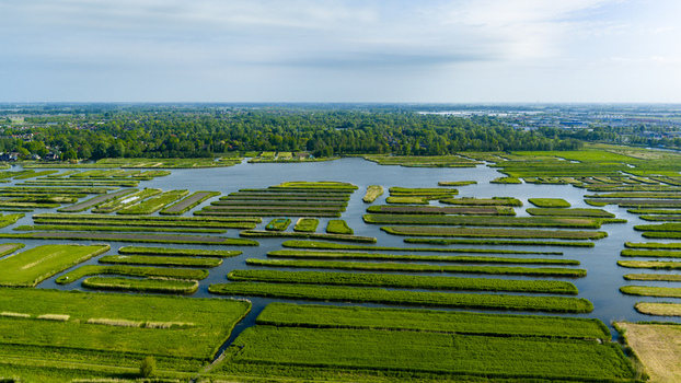 Aerial view of the Oosterdel nature reserve with its unique landscape of narrow green islands and water channels in Broek op Langedijk Noord Holland Netherlands. Aerial view of the Oosterdel nature reserve with its unique landscape of narrow green islands and water channels in Broek op Langedijk Noord Holland Netherlands.