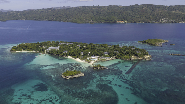 Aerial view of Cayo Levantado Beach featuring lush tropical vegetation white sand and turquoise waters in Samana SAMANA Dominican Republic. Aerial view of Cayo Levantado Beach featuring lush tropical vegetation white sand and turquoise waters in Samana SAMANA Dominican Republic.