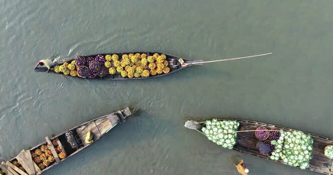 Aerial view of wooden boats with colorful produce Bangladesh.