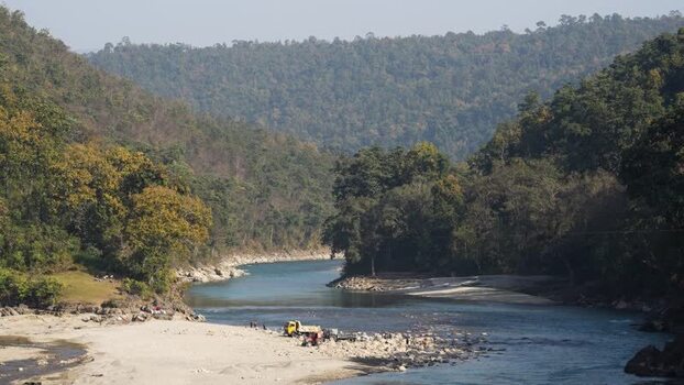 View of a river flowing through a forested valley Nepal.