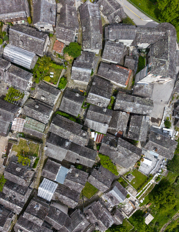 Aerial view of Corippo Albergo Diffuso featuring traditional stone houses with grey slate roofs nestled in the lush green landscape of Corippo Ticino Switzerland. Aerial view of Corippo Albergo Diffuso featuring traditional stone houses with grey slate roofs nestled in the lush green landscape of Corippo Ticino Switzerland.