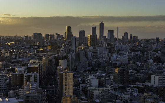 View of a sprawling cityscape bathed in the warm glow of the setting sun with modern skyscrapers casting long shadows across the urban landscape Bunkyo City Tokyo Japan. View of a sprawling cityscape bathed in the warm glow of the setting sun with modern skyscrapers casting long shadows across the urban landscape Bunkyo City Tokyo Japan.
