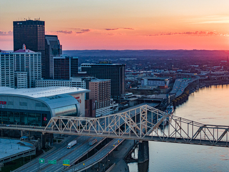 Aerial view of the downtown skyline KFC Yum Center and bridges over the Ohio River during a vibrant sunset in Louisville Kentucky United States. Aerial view of the downtown skyline KFC Yum Center and bridges over the Ohio River during a vibrant sunset in Louisville Kentucky United States.