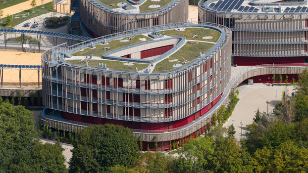 Durmersheim Germany 12 September 2026 Aerial view of Wilhelm Hausenstein Gymnasium featuring modern architecture with a green roof solar panels and surrounding sports facilities.