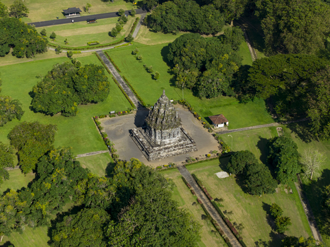 Aerial view of Bubrah Temple surrounded by lush green lawns and dense tropical trees under bright sunlight Kecamatan Prambanan Jawa Tengah Indonesia. Aerial view of Bubrah Temple surrounded by lush green lawns and dense tropical trees under bright sunlight Kecamatan Prambanan Jawa Tengah Indonesia.