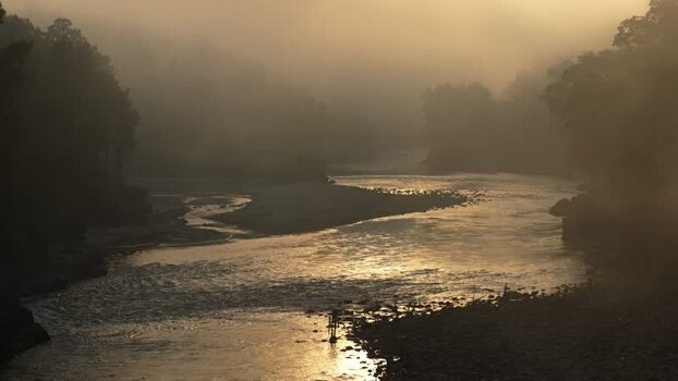 View of a misty river at sunrise Nepal.