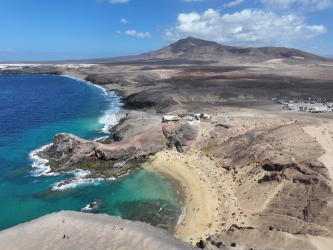 Aerial view of Papagayo Beach with golden sand turquoise waters and volcanic cliffs in Lanzarote. Aerial view of Papagayo Beach with golden sand turquoise waters and volcanic cliffs in Lanzarote.