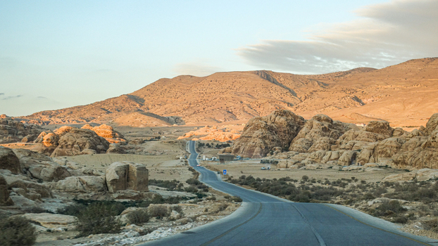 View of the winding road through the rocky landscape of Wadi Rum Desert in Wadi Rum Village Aqaba Governorate Jordan. View of the winding road through the rocky landscape of Wadi Rum Desert in Wadi Rum Village Aqaba Governorate Jordan.
