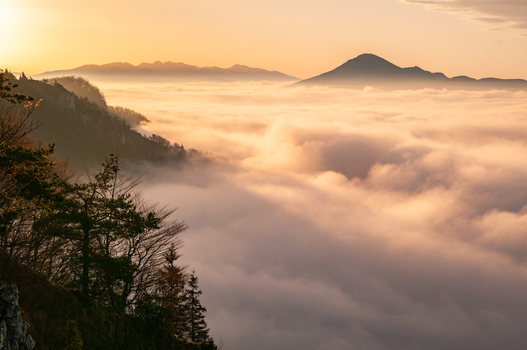 Aerial view of Sip mountain in Mala Fatra rising above a dense sea of clouds during golden hour in Stankovany Zilina Region Slovakia. Aerial view of Sip mountain in Mala Fatra rising above a dense sea of clouds during golden hour in Stankovany Zilina Region Slovakia.