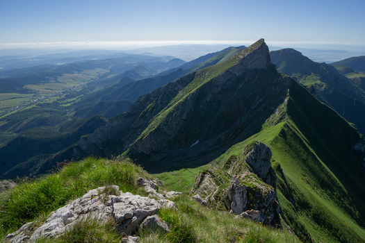 View of the sharp mountain ridge of Zdiarska vidla in the Belianske Tatry range with green slopes and rocky peaks under a clear blue sky near Zdiar Presov Region Slovakia. View of the sharp mountain ridge of Zdiarska vidla in the Belianske Tatry range with green slopes and rocky peaks under a clear blue sky near Zdiar Presov Region Slovakia.