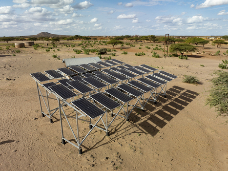 Aerial view of a solar panel array installed in the arid desert landscape of Marsabit County Kenya. Aerial view of a solar panel array installed in the arid desert landscape of Marsabit County Kenya.