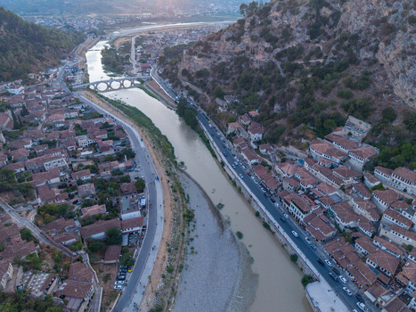 Aerial view of the historic town of Berat featuring traditional Ottoman style houses with terracotta roofs lining the Osum River in Berat Berat County Albania.