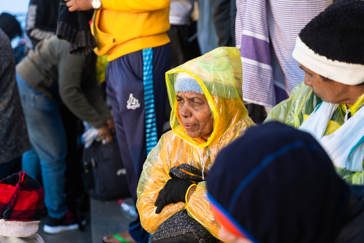 Ratnapura Sri Lanka 23 February 2026 View of pilgrims and visitors gathered at Adam s Peak wearing warm clothing and raincoats during the early morning ascent.