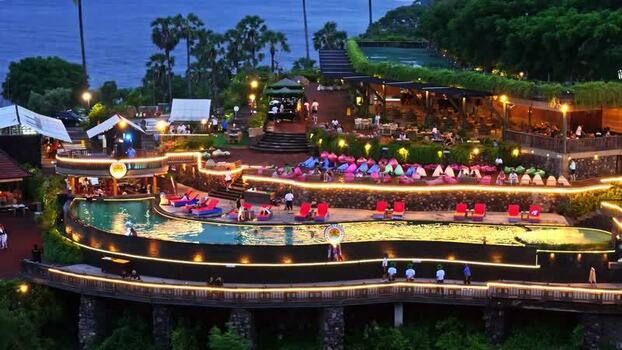 Aerial view of cliffside resort with infinity pool Indonesia.
