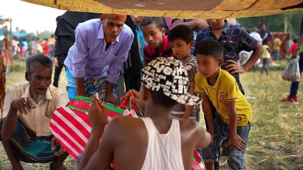 View of people gathered around a kite in Bogura Bangladesh. View of people gathered around a kite in Bogura Bangladesh.