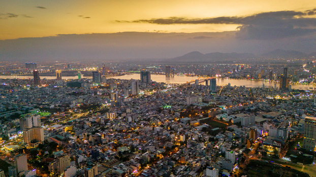 Aerial view of Da Nang city at sunset with the river and bridge illuminated by warm evening light in Da Nang Vietnam. Aerial view of Da Nang city at sunset with the river and bridge illuminated by warm evening light in Da Nang Vietnam.