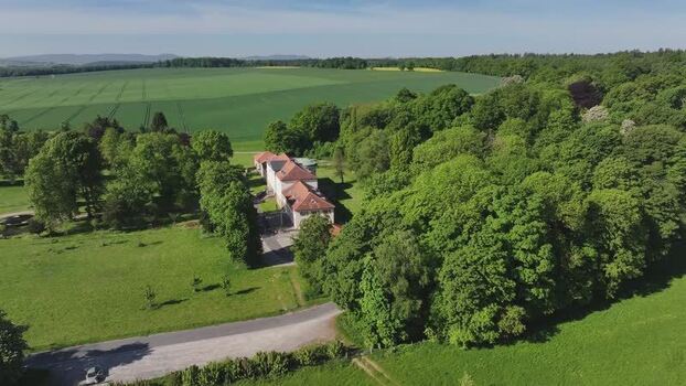 Aerial view of a historic estate surrounded by lush green forests Germany. Aerial view of a historic estate surrounded by lush green forests Germany.