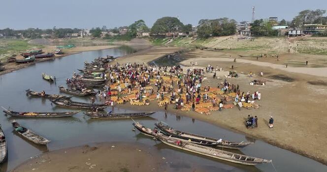 Aerial view of a riverside market and wooden boats Bangladesh.