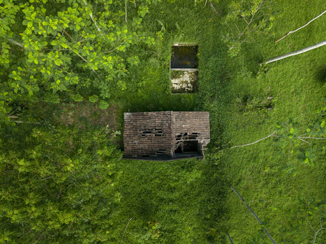 Aerial view of an abandoned house with a damaged tiled roof surrounded by dense green vegetation and trees in Cangkringan Special Region of Yogyakarta Indonesia. Aerial view of an abandoned house with a damaged tiled roof surrounded by dense green vegetation and trees in Cangkringan Special Region of Yogyakarta Indonesia.